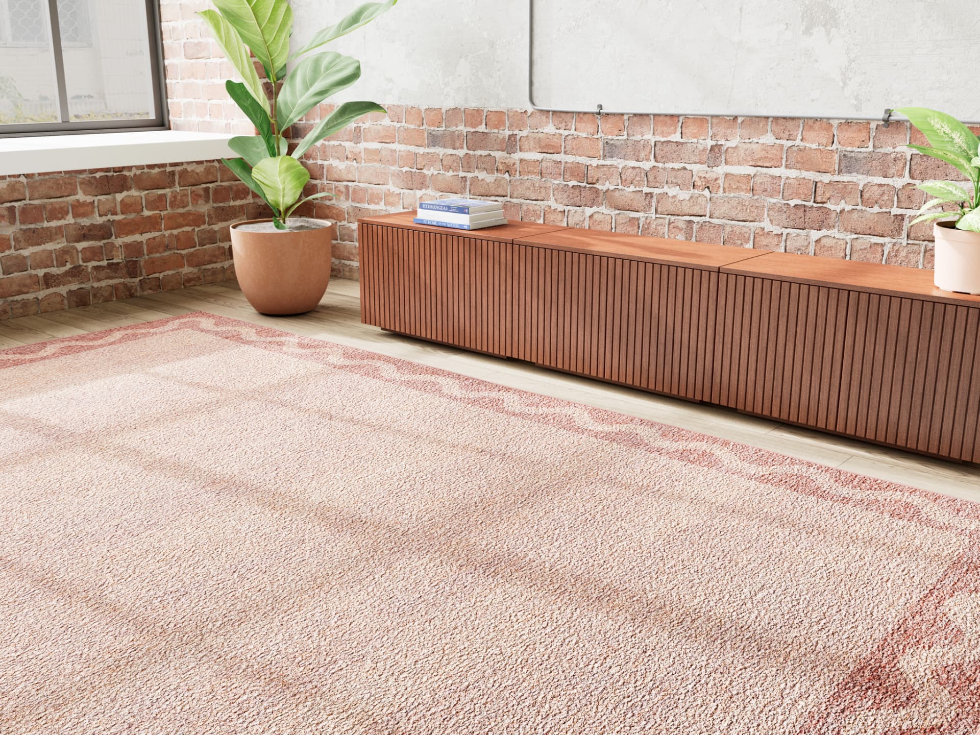 Burnt sienna washable rug in a brick-walled room with plants