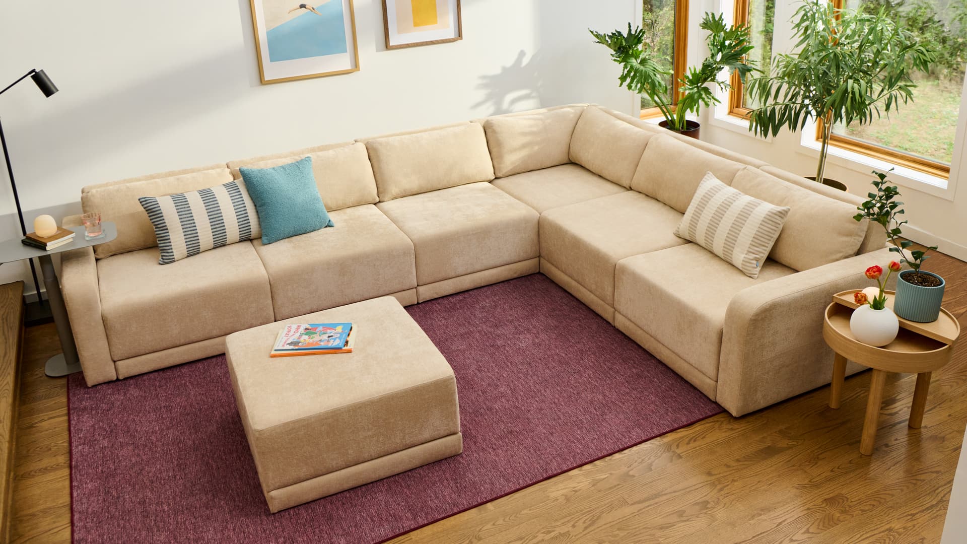 Cream Cozey Orian L-shaped sectional with an ottoman on a purple rug
