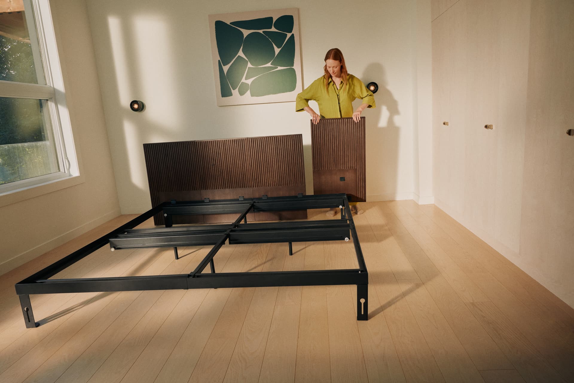 A person assembling a bed frame